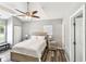 Bright bedroom with a ceiling fan, ensuite bathroom, and closet space at 6207 Gulfport S Blvd, Gulfport, FL 33707