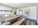 Bright dining room with a large window, wood floors, and a contemporary table set at 6207 Gulfport S Blvd, Gulfport, FL 33707