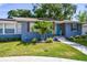 Inviting curb appeal with mature landscaping, wooden accents, and a cozy front porch at 6207 Gulfport S Blvd, Gulfport, FL 33707