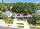 Charming home with a well-manicured lawn, driveway, and solar panels on the roof at 6207 Gulfport S Blvd, Gulfport, FL 33707