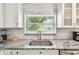 Close up of the kitchen sink with a stainless steel sink and granite countertops at 6207 Gulfport S Blvd, Gulfport, FL 33707