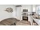 Well-lit kitchen with stainless steel appliances and a wooden table for dining at 6207 Gulfport S Blvd, Gulfport, FL 33707