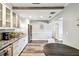 Spacious kitchen with white cabinetry, stainless steel appliances, and a dining table at 6207 Gulfport S Blvd, Gulfport, FL 33707
