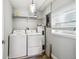 Laundry room with washer, dryer, and shelving for supplies at 6207 Gulfport S Blvd, Gulfport, FL 33707