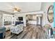 Open-concept living room with hardwood floors, modern furniture, and an archway leading into the kitchen at 6207 Gulfport S Blvd, Gulfport, FL 33707