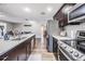 Modern kitchen features stainless steel appliances and an island with sink and stone countertops at 6333 Aberdeen Ave, New Port Richey, FL 34653