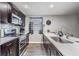 Well-lit kitchen featuring modern appliances, sleek countertops, and dark wood cabinets at 6333 Aberdeen Ave, New Port Richey, FL 34653