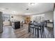 Open kitchen layout with eat-in island, stainless appliances, and a dining area with large windows at 6333 Aberdeen Ave, New Port Richey, FL 34653