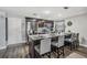 Kitchen has an eat-in island with stone countertops, modern appliances and dark cabinets at 6333 Aberdeen Ave, New Port Richey, FL 34653