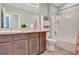 Bathroom featuring a double sink vanity, modern fixtures, a toilet, and a shower-tub combination with white tile surround at 6648 Seaway Dr, Brooksville, FL 34604