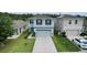 Two-story home featuring a two-car garage, well-maintained lawn, and neatly trimmed landscaping at 6648 Seaway Dr, Brooksville, FL 34604