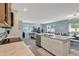 Well-lit kitchen with stainless appliances and a view to the dining and living space at 6648 Seaway Dr, Brooksville, FL 34604