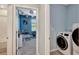 Bright laundry area, with modern washer and dryer, conveniently located adjacent to a colorful, carpeted bedroom or playroom at 6648 Seaway Dr, Brooksville, FL 34604