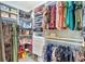 Well-organized walk-in closet with ample shelving and hanging space for clothes, handbags, and accessories at 6648 Seaway Dr, Brooksville, FL 34604