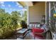 Outdoor seating on the cozy porch, perfect for relaxing and enjoying nature at 6922 Duffy Ln, Tampa, FL 33616