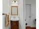 Half bathroom featuring a vanity with sink, mirror, and modern fixtures at 6922 Duffy Ln, Tampa, FL 33616