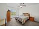 Comfortable bedroom with a large window and neutral decor, featuring a ceiling fan at 6922 Duffy Ln, Tampa, FL 33616