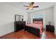 Cozy bedroom with hardwood floors, ceiling fan, and a window to allow for great natural light at 6922 Duffy Ln, Tampa, FL 33616