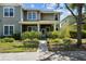 Charming two-story home with a welcoming front porch, beautiful landscaping, and a brick walkway at 6922 Duffy Ln, Tampa, FL 33616