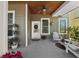 Inviting front porch with wood ceiling, comfortable seating, and decorative plants at 6922 Duffy Ln, Tampa, FL 33616