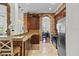 Gourmet kitchen featuring brick archway, granite counters, and stainless steel refrigerator at 6922 Duffy Ln, Tampa, FL 33616