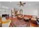 Open-concept living room with stylish furnishings and hardwood floors, leading to kitchen at 6922 Duffy Ln, Tampa, FL 33616