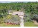 Aerial view of home showing spacious lot, landscaping, and surrounding greenery at 6938 Coronet Dr, New Port Richey, FL 34655