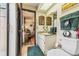 Bathroom with a view of the adjacent bedroom, featuring a vanity, toilet, and a skylight at 6938 Coronet Dr, New Port Richey, FL 34655