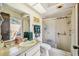 Functional bathroom featuring a shower, vanity with counter space, and an adjacent outdoor patio at 6938 Coronet Dr, New Port Richey, FL 34655