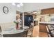 Cozy breakfast nook with table, adjacent to the kitchen featuring wood cabinets and a black refrigerator at 6938 Coronet Dr, New Port Richey, FL 34655