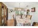 Bright dining room features an elegant chandelier and floral tablecloth at 6938 Coronet Dr, New Port Richey, FL 34655