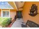 Charming front porch with tiled flooring, garden bench, and decorative fountain accent at 6938 Coronet Dr, New Port Richey, FL 34655