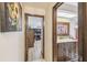 Hallway view leading to a bathroom with decorative vanity and a bedroom with a desk setup at 6938 Coronet Dr, New Port Richey, FL 34655