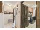 Bright hallway featuring tiled floors, closet with louvered doors and views into the laundry area at 6938 Coronet Dr, New Port Richey, FL 34655