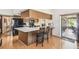 Kitchen island with chairs offers views into the patio at 6938 Coronet Dr, New Port Richey, FL 34655