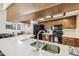 Bright kitchen with stone countertops, black appliances, and stylish faucet at 6938 Coronet Dr, New Port Richey, FL 34655
