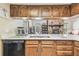 Well-appointed kitchen with stone countertops and oak cabinets at 6938 Coronet Dr, New Port Richey, FL 34655