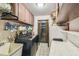 Functional laundry room with washer, dryer, sink, and storage cabinets for household supplies at 6938 Coronet Dr, New Port Richey, FL 34655