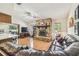 Spacious living room features a stone fireplace, wood floors, and abundant natural light at 6938 Coronet Dr, New Port Richey, FL 34655