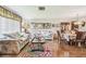 Inviting living room with floral furniture, wood floors, and dining area at 6938 Coronet Dr, New Port Richey, FL 34655