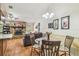Open-concept living room with stone fireplace, wood floors, and modern dining area at 6938 Coronet Dr, New Port Richey, FL 34655