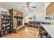 Living room boasts a stone fireplace, wood floors, and view into open kitchen at 6938 Coronet Dr, New Port Richey, FL 34655