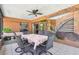 Enclosed patio featuring a dining table, fan, and decorative wall art at 6938 Coronet Dr, New Port Richey, FL 34655