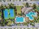 Aerial view showcasing the community's tennis courts, swimming pools, and clubhouse, designed for leisure at 7207 Peregrina Loop, Wesley Chapel, FL 33545