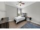 Bedroom features natural light, wooden bedframe, dresser and a blue and grey rug, complemented by crown molding at 7207 Peregrina Loop, Wesley Chapel, FL 33545