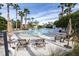 Resort-style community pool with lounge seating, tables, and a splash fountain at 7207 Peregrina Loop, Wesley Chapel, FL 33545