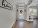 Bright and welcoming foyer features hardwood floors, decorative accents, and views into adjacent living spaces at 7207 Peregrina Loop, Wesley Chapel, FL 33545