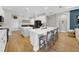 Open kitchen with white cabinets, a large island, and adjacent dining area at 7207 Peregrina Loop, Wesley Chapel, FL 33545