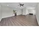 A spacious living room with hardwood flooring, recessed lighting, and a ceiling fan at 7207 Peregrina Loop, Wesley Chapel, FL 33545