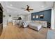 Open-concept living room with view to the kitchen and access to the pool at 7207 Peregrina Loop, Wesley Chapel, FL 33545